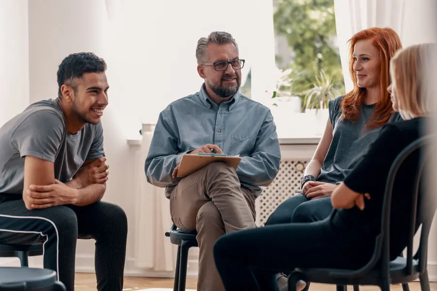 group of friends smiling and laughing after receiving treatment for mental health