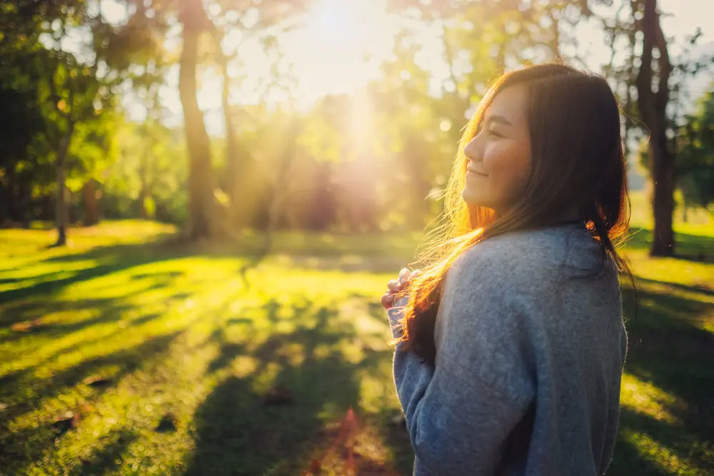 woman smiling outside who is in a mental health treatment program