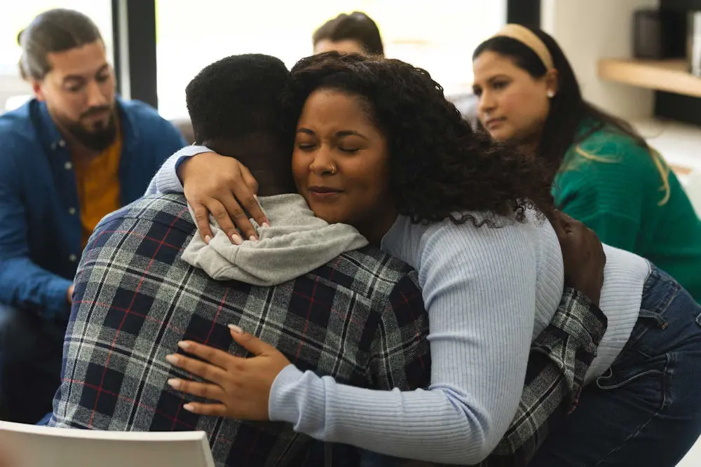woman hugging another at the end of a therapy session