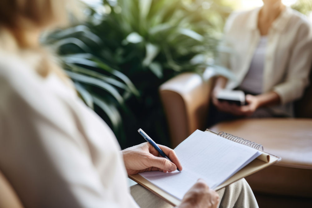 therapist taking notes during session