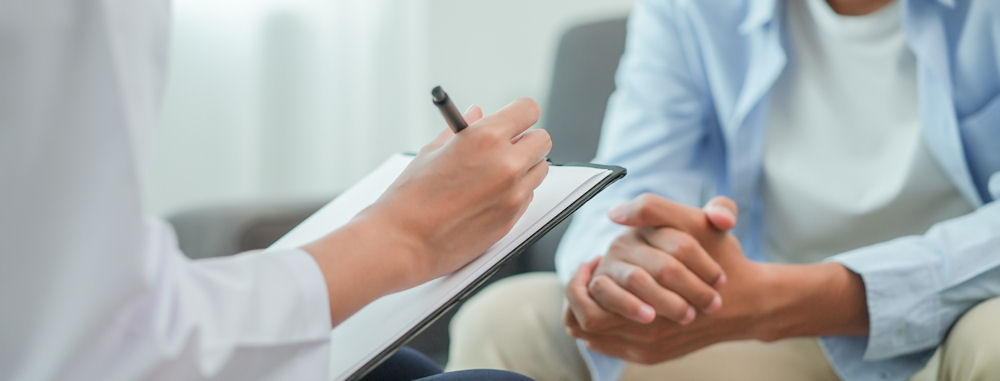 Therapist taking notes during therapy for stress