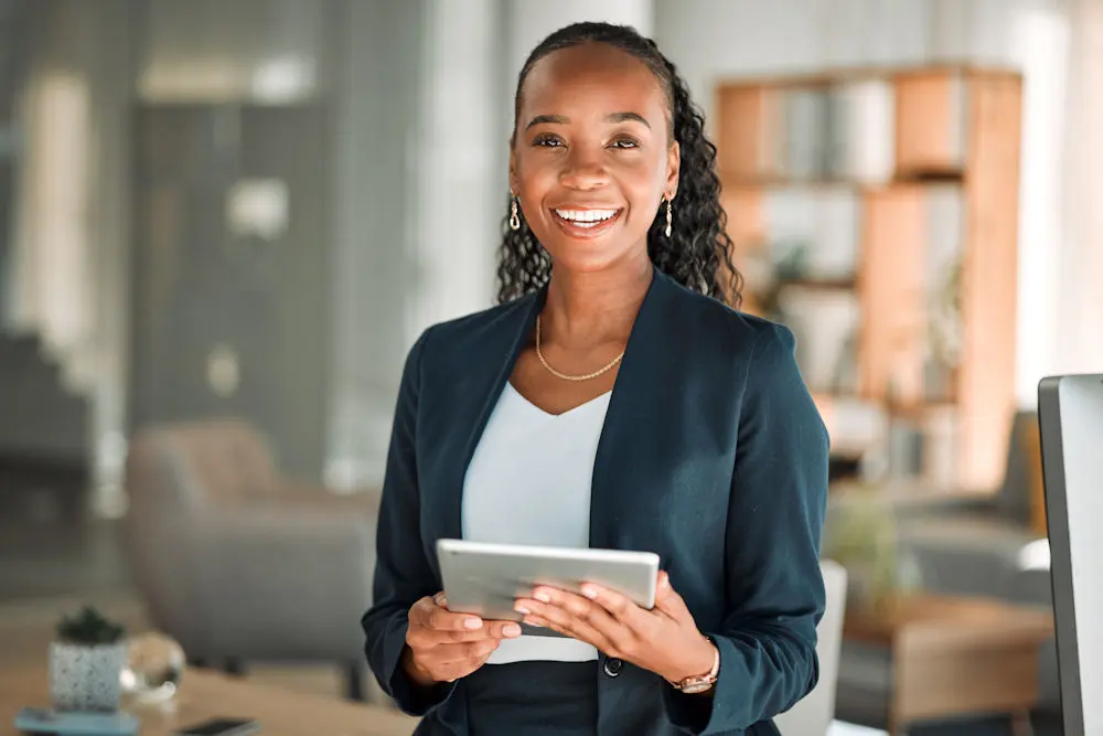Therapist with tablet looking out with encouraging smile