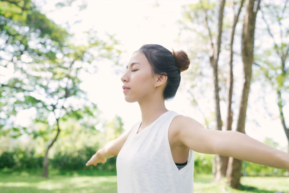 Woman with seasonal depression performing yoga outdoors