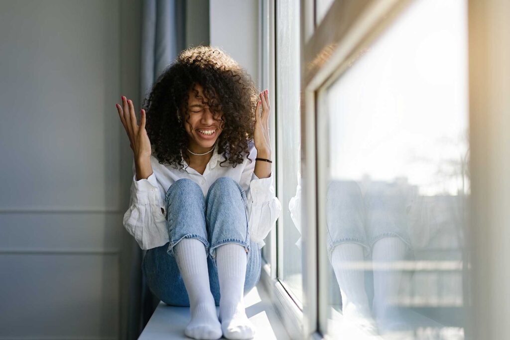 Excited woman happy after cleaning for mental health.