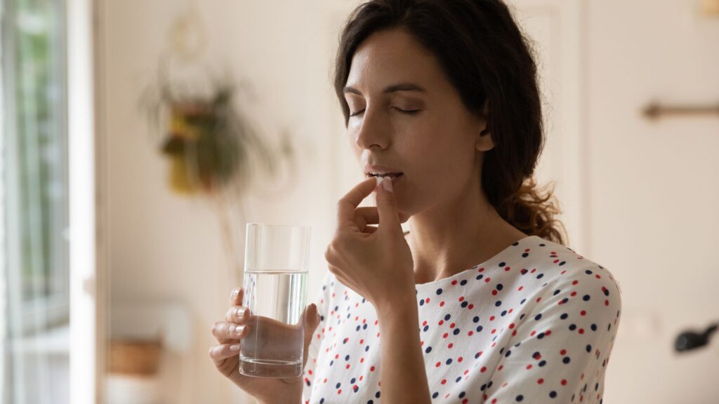 photo of a woman taking medicine and wondering how long do antidepressants take to work